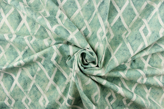 This fabric features a geometric diamond design in a blue green and dull white.