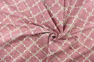  This fabric features a geometric design in a off white with khaki against a rose pink background.