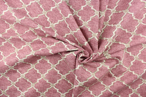  This fabric features a geometric design in a off white with khaki against a rose pink background.