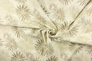  This fabric features a firework like design in tones of brown, khaki against a off white background. 