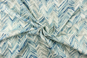 This fabric features a chevron design in shades of blue and gray and white. 