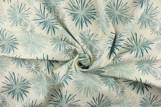 This fabric features a firework like design in teal blue tones and off white with hints of gray.