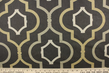 Load image into Gallery viewer, This fabric features a large geometric design in tan, light khaki, and taupe against a dark gray background. 
