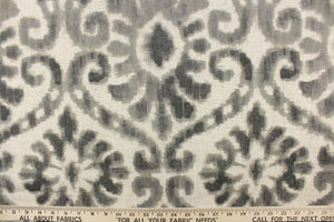  This fabric features a damask design in gray tones with hints of taupe against a natural background. 