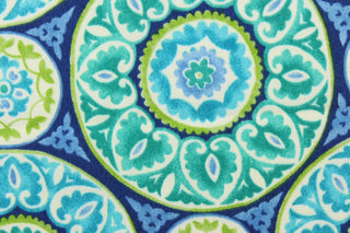 This fabric features a intricate circular design and is perfect for any project where the fabric will be exposed to the weather. Colors included are green, white and shades of blue.