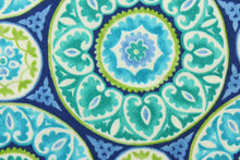 Load image into Gallery viewer, This fabric features a intricate circular design and is perfect for any project where the fabric will be exposed to the weather. Colors included are green, white and shades of blue.
