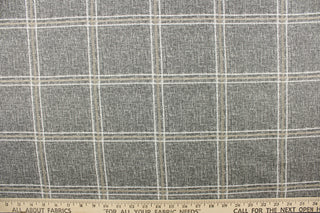 This multi functional fabric features white and khaki stripes on a gray background. 