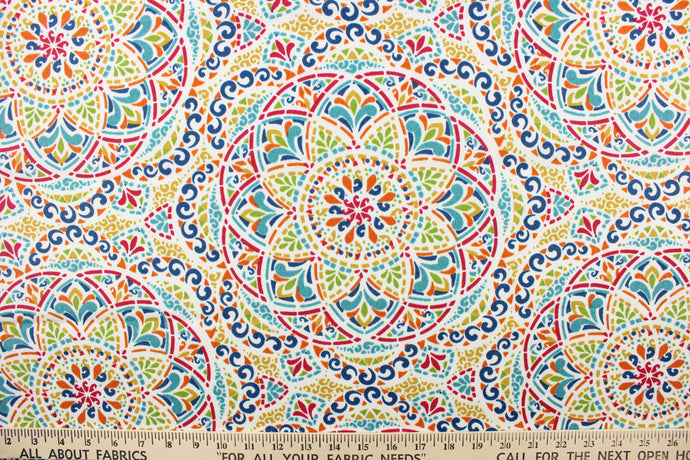  This fabric features a colorful geometric design and is perfect for any project where the fabric will be exposed to the weather.  Colors included are red, shades of blue, orange, green and white.  