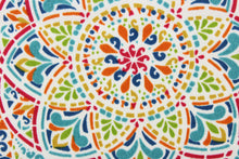 Load image into Gallery viewer, This fabric features a colorful geometric design and is perfect for any project where the fabric will be exposed to the weather. Colors included are red, shades of blue, orange, green and white.
