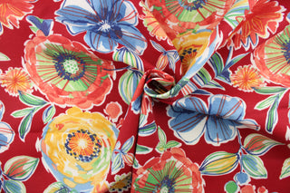 This screen printed fabric features large colorful flowers set against a solid background and is perfect for any project where the fabric will be exposed to the weather. Colors include red, coral, yellow, orange, blue, green, grey, and white.