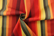 Load image into Gallery viewer, This heavy striped fabric in autumnal colors is perfect for any project where the fabric will be exposed to the weather. Colors include shades of red, orange, yellow and green.
