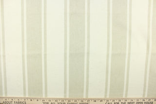 This fabric features stripes in natural on a light beige background. 