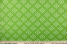 Load image into Gallery viewer, This beautiful outdoor fabric features a geometric design in white on a green background.
