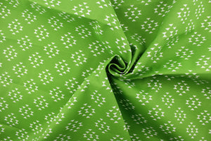 This beautiful outdoor fabric features a geometric design in white on a green background.