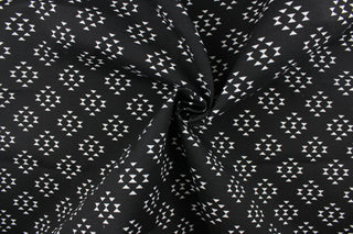 This screen printed outdoor fabric features a geometric design in white on a black background.  