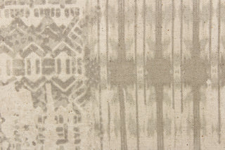 This multi functional fabric features an abstract design in taupe on a beige background.  