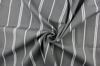 This outdoor fabric features white stripes set against a gray background.