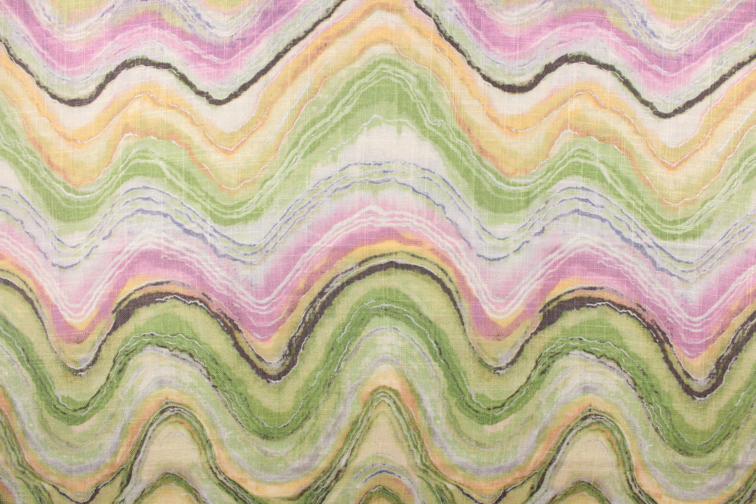 This screen printed fabric features abstract waves in shades of green, yellow, pink, purple and brown with metallic silver accents. 