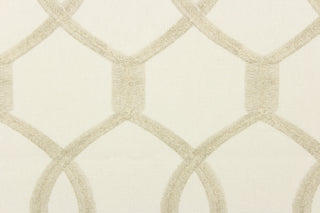 This fabric features interlocking ovals in khaki on a off white background. 