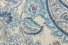 Load image into Gallery viewer, This fabric features a paisley and floral print on a light sand slubbed ground.  Colors included are blue, gray, tan, cream and metallic silver. 
