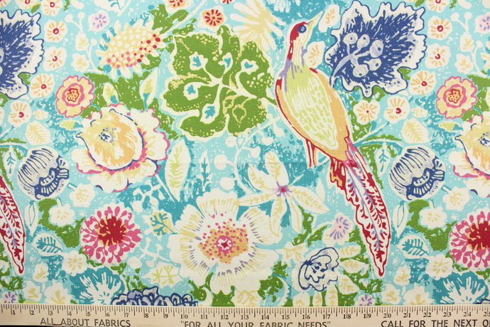 This fabric features a novelty bird and floral print on a light aqua blue background.  Colors included are teal, blue, green and red.