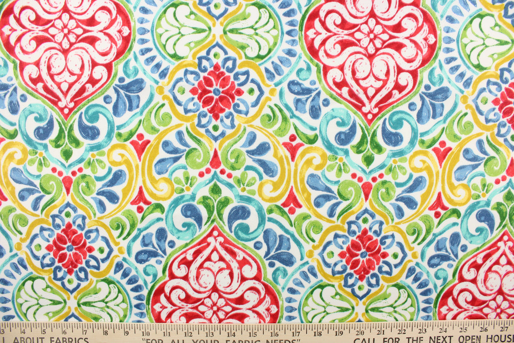 This outdoor fabric features a damask design in bright colors of pink, yellow, blue, teal and green against white background.