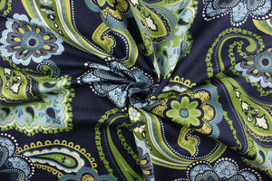 This fabric features a floral paisley design in shades of blue, green, off white and a yellowish green against a navy background.