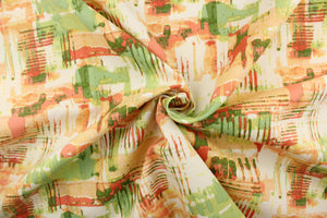 This outdoor fabric features an abstract design in varying shades of orange, peach, green, and white with hints of yellow. 