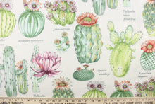 Load image into Gallery viewer, This outdoor fabric features a design of different  cactus in green, orange, purple, and peach with hints golden yellow against white.
