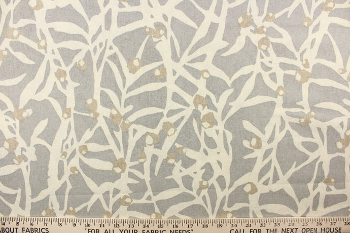 This fabric features a branch design in off white, and beige against a gray background. 