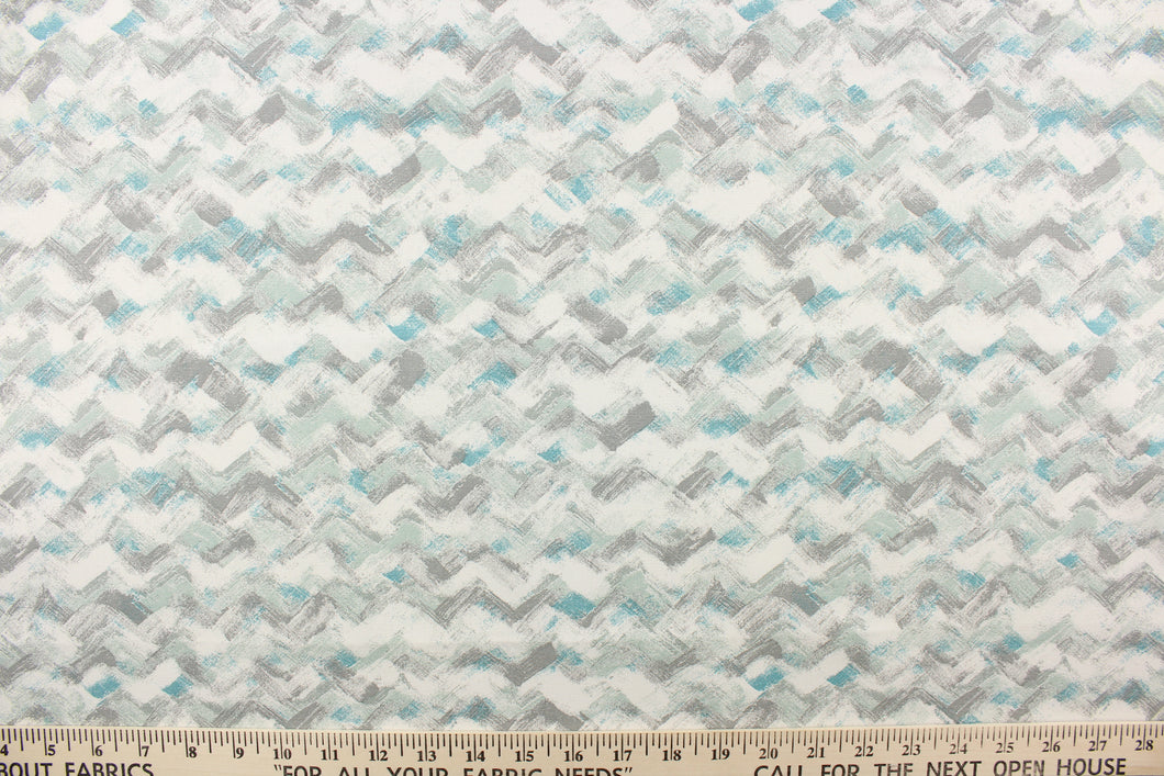 This fabric features a chevron design in grays, white, seafoam green, and teal blue .