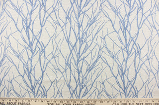 This fabric features a branch design in blue against a pale gray background.