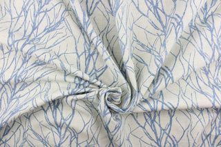 This fabric features a branch design in blue against a pale gray background.