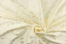 Load image into Gallery viewer, This luxurious duotone fabric features embroidered foliage on a silky cream background.
