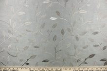 Load image into Gallery viewer, This luxurious duotone fabric features embroidered foliage on a silky slate gray background.
