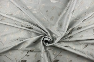 This luxurious duotone fabric features embroidered foliage on a silky slate gray background.