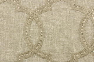  This fabric features a modern geometric design artfully embroidered in champagne gold on a linen colored background. 