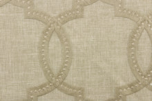 Load image into Gallery viewer,  This fabric features a modern geometric design artfully embroidered in champagne gold on a linen colored background. 
