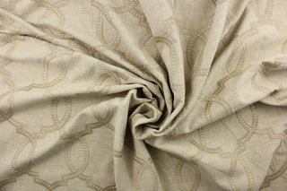  This fabric features a modern geometric design artfully embroidered in champagne gold on a linen colored background. 