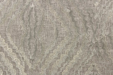 Load image into Gallery viewer, This fabric features a unique design in pewter and has a shimmer that enhances the design.
