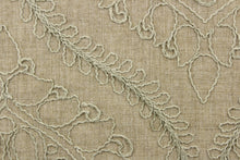 Load image into Gallery viewer, This fabric features an embossed medallion design in light green on a dark beige background.  
