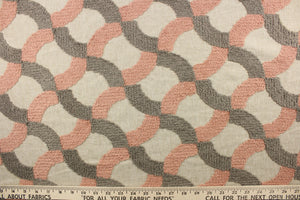 This fabric features an embossed lattice design in pink and gray on a natural colored background. 