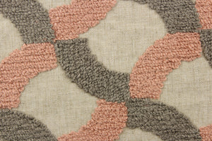 This fabric features an embossed lattice design in pink and gray on a natural colored background. 