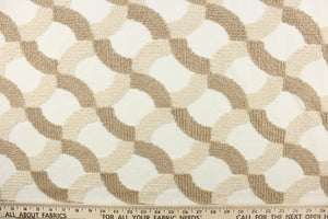 This fabric features an embossed lattice design in light brown and beige  on a white background.