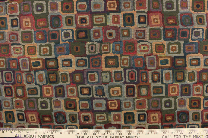 This tapestry fabric features box shapes in gemstone colors that is woven into the fabric.   Colors included are red, blue, green. 