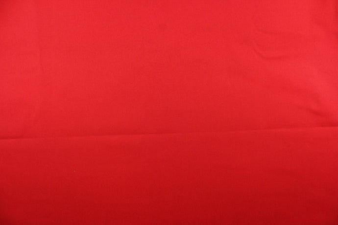 Twill fabric in a solid red .