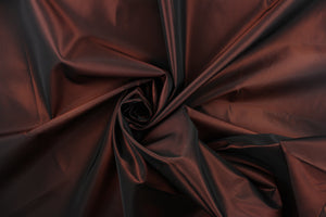 This taffeta fabric in iridescent brownish red