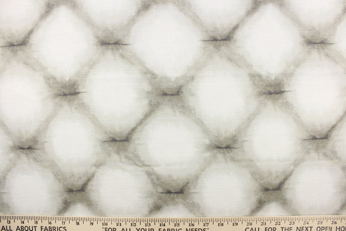 This fabric features a geometric design in brownish gray against white.