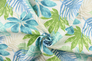  This outdoor fabric features a floral design in blue, teal, green, and light khaki against white. 