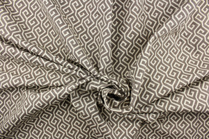This fabric features a geometric design in a dull white and brownish gray. 